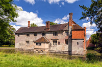 A rear view of Baddesley Clinton Manor House showing the moat, July 2017